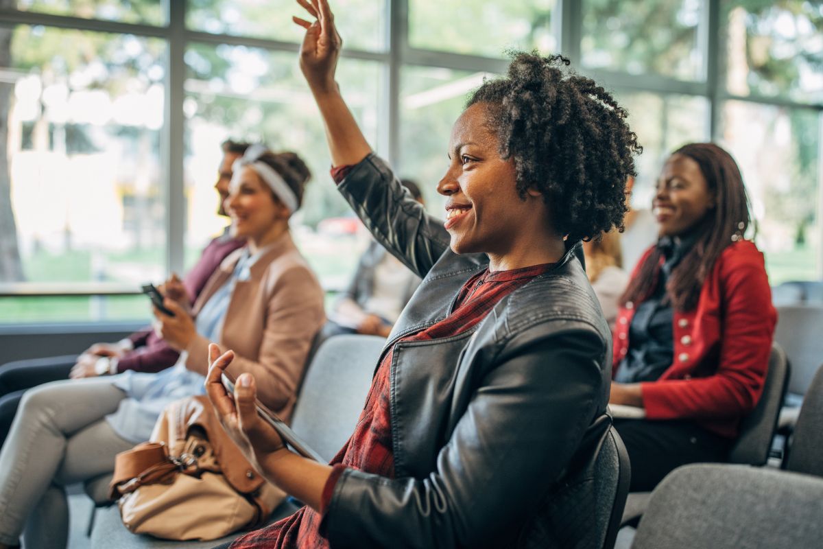 Seminar audience raising hands